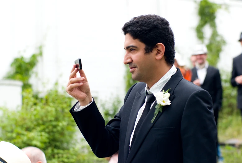 a man in a suit holding a cell phone