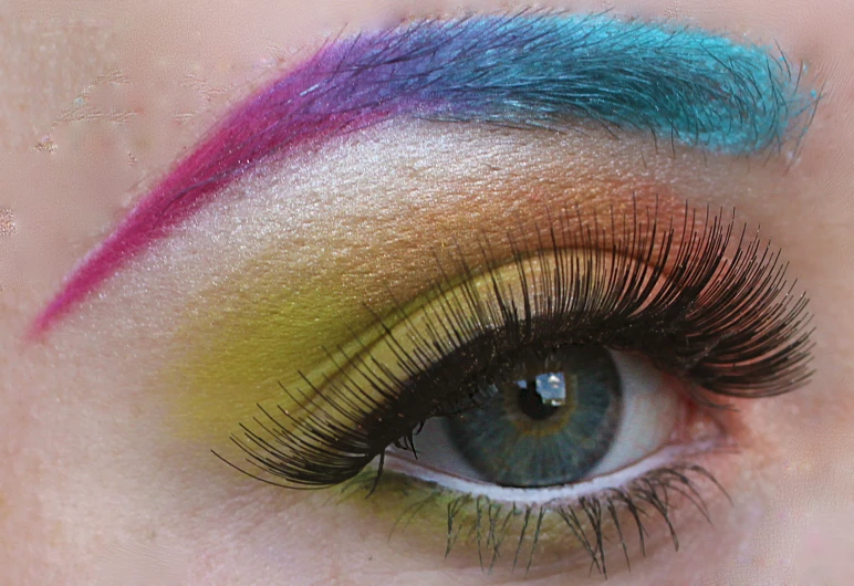 a female with a multi colored make - up is shown in this close up s