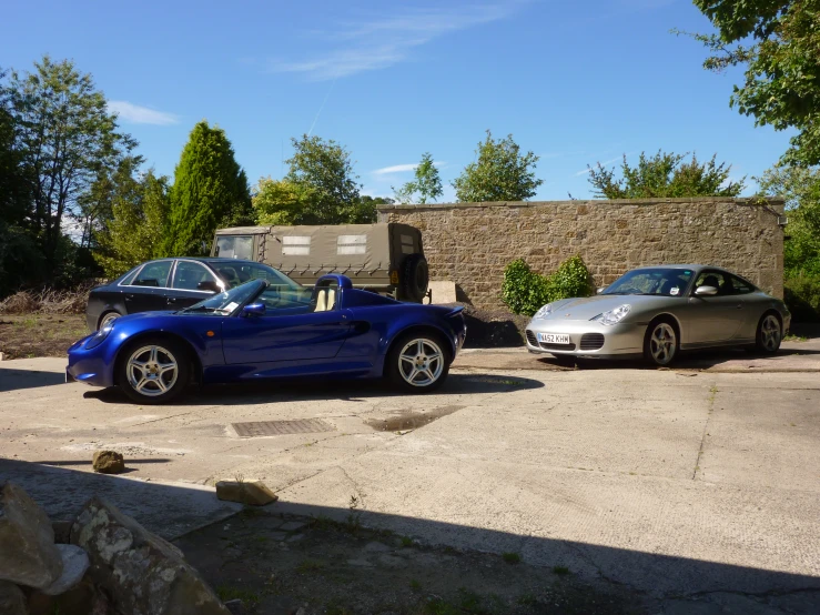 two cars are shown parked in an open lot