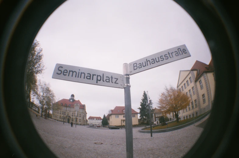 the intersection of two streets, with one sign and the other on a pole