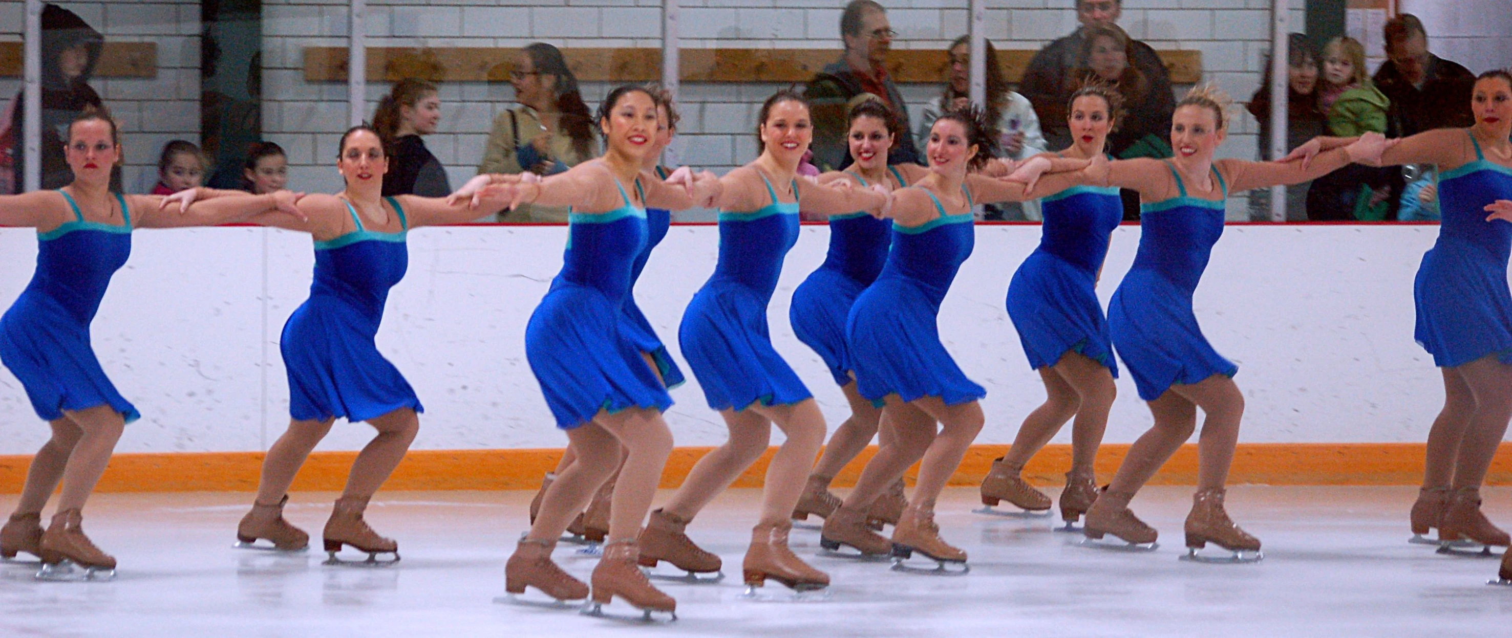 an image of five people that are skating