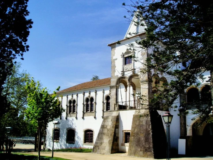 an older white building with a clock on top