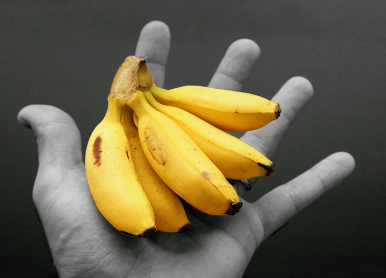 a banana that has been placed in someones palm