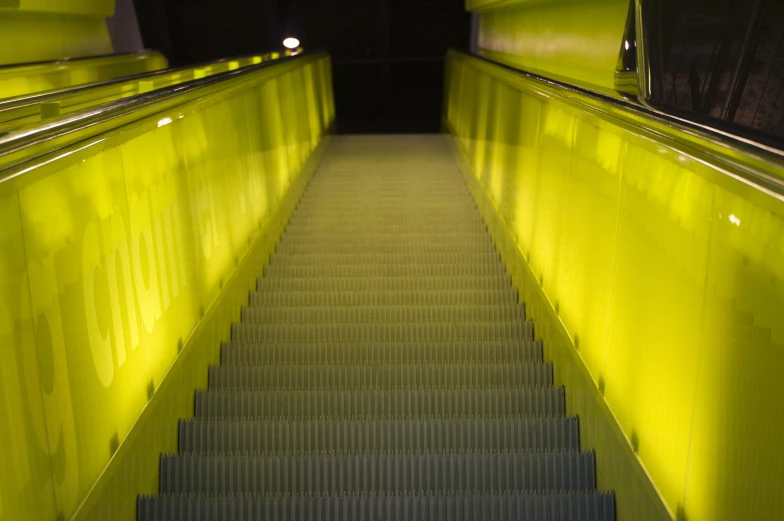the stairway is painted bright yellow with a light on