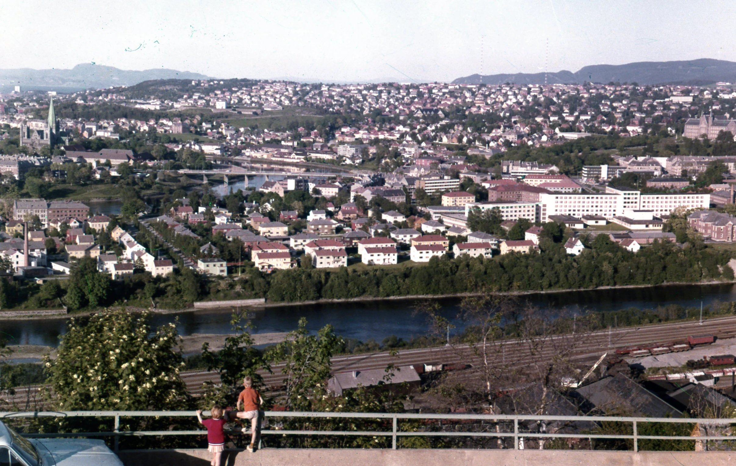 a couple walking towards the city in a valley