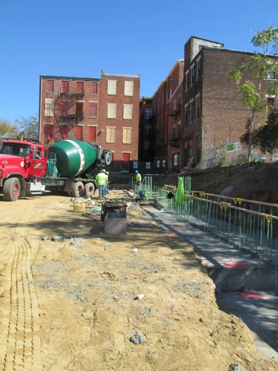 construction equipment including a green machine sits in the street