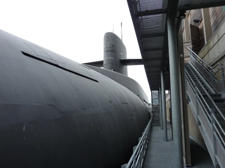 a long black submarine with stairs leading to it