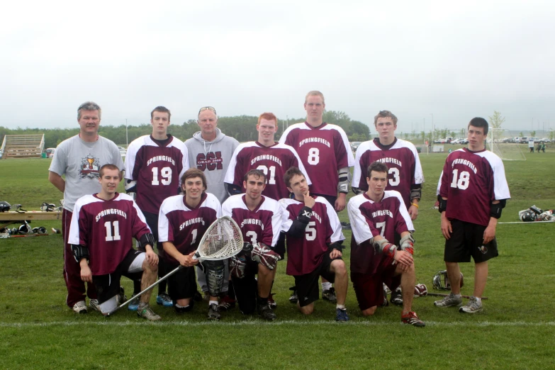 a lacrosse team poses for a group pograph