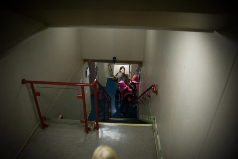 a group of people standing at the top of a stairwell