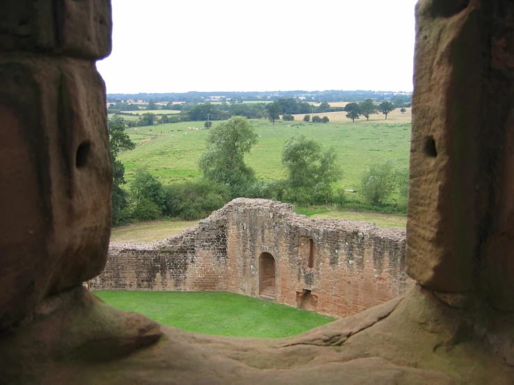 an open window shows a field and a tower