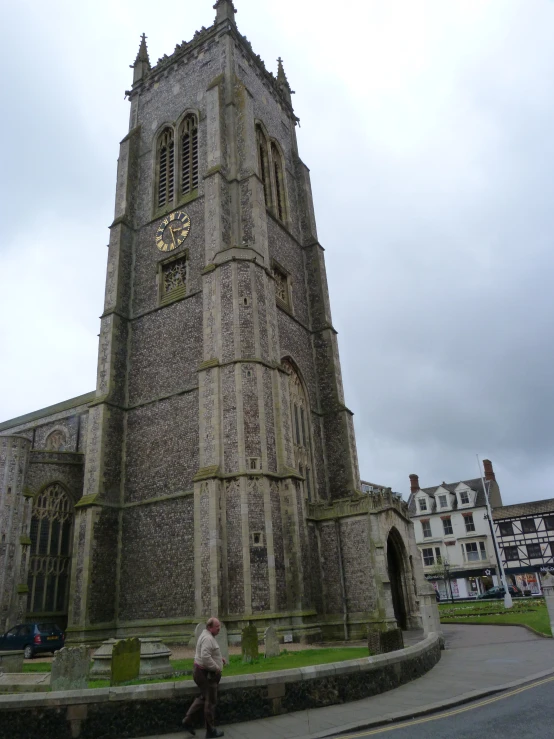 a tall gray building with clock on top