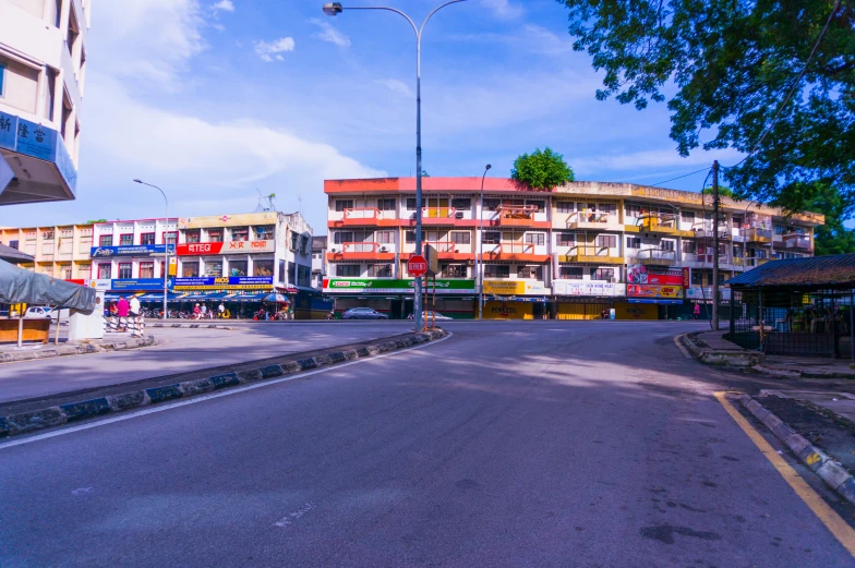 an empty city street with buildings in the background