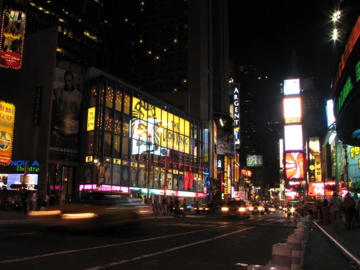 a busy city street at night with bright lights