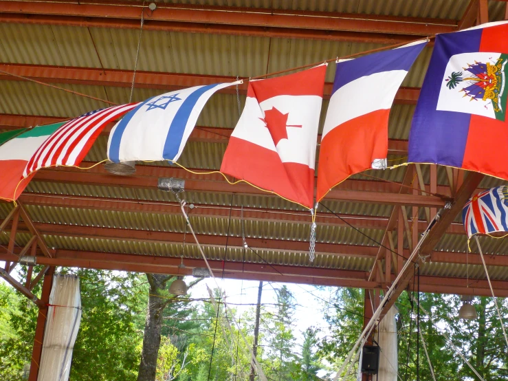 flags hanging on the ceiling of a pavilion