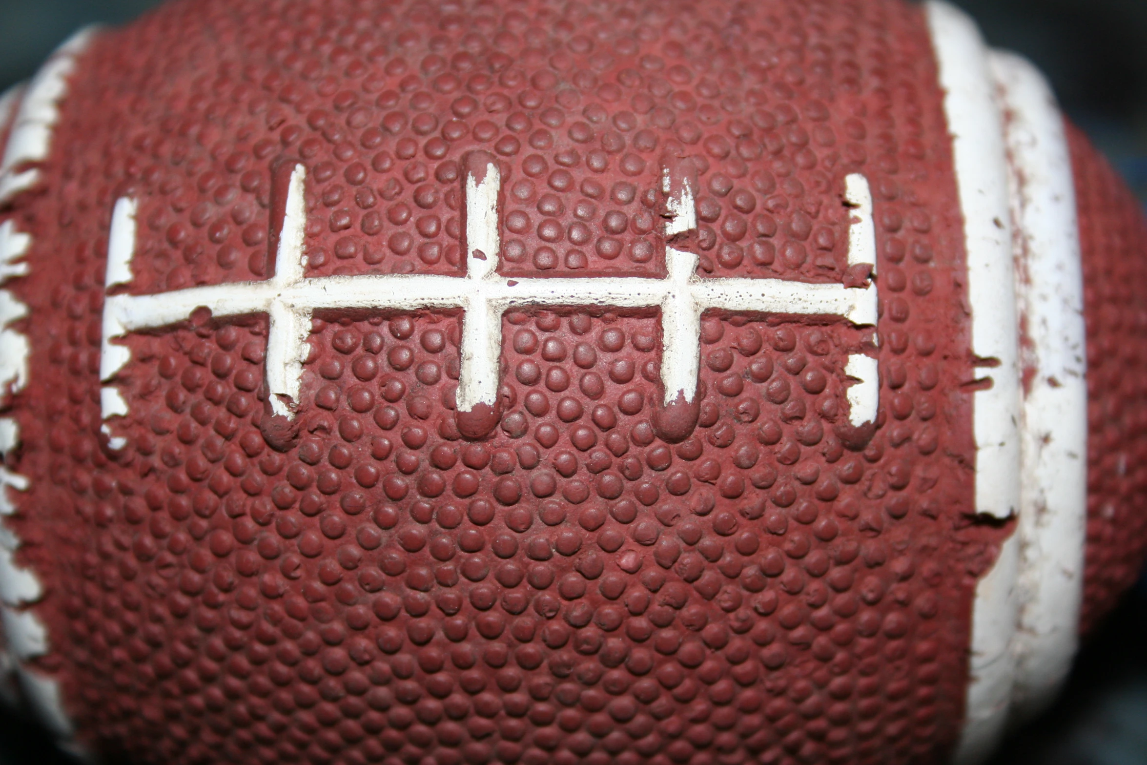 an old worn out, worn out football is displayed