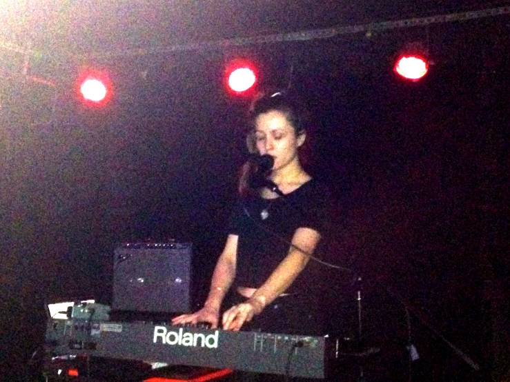 girl playing keyboard with red lights on the side