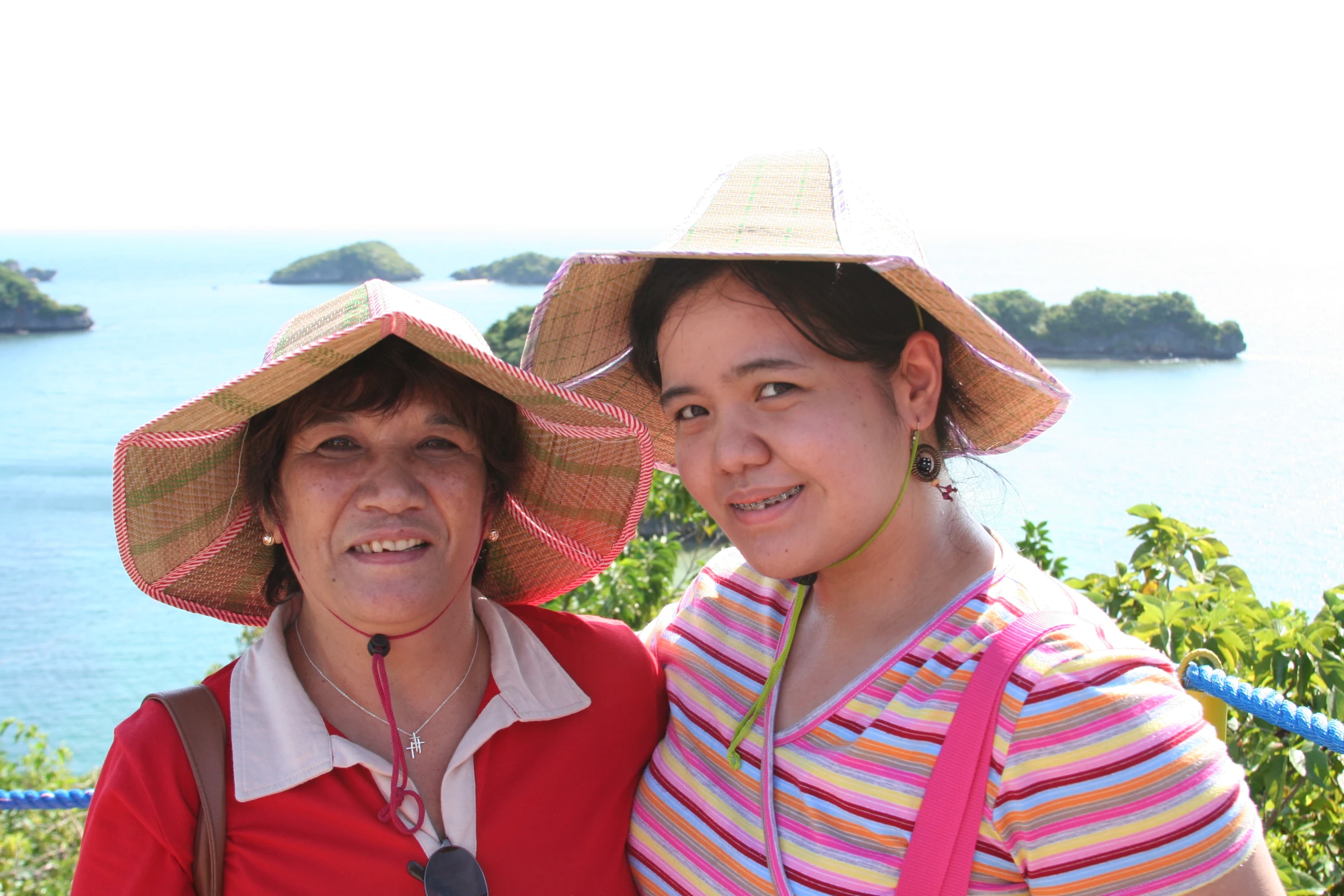 two women in matching hats pose for a picture