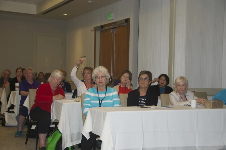 many women are sitting at the long table