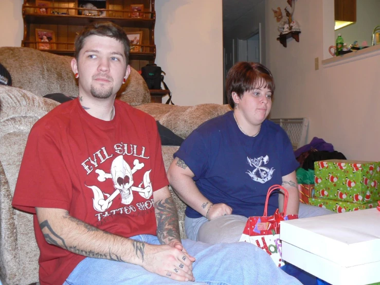 two people sitting on a couch in the room