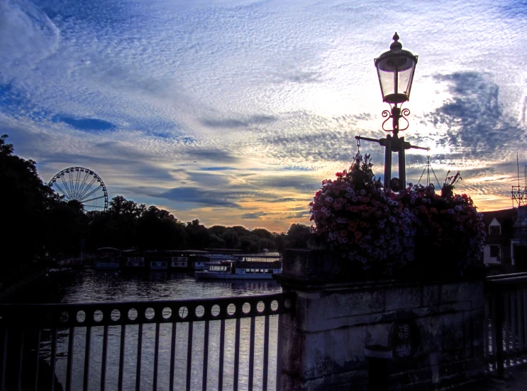 a street light sitting on the side of a river