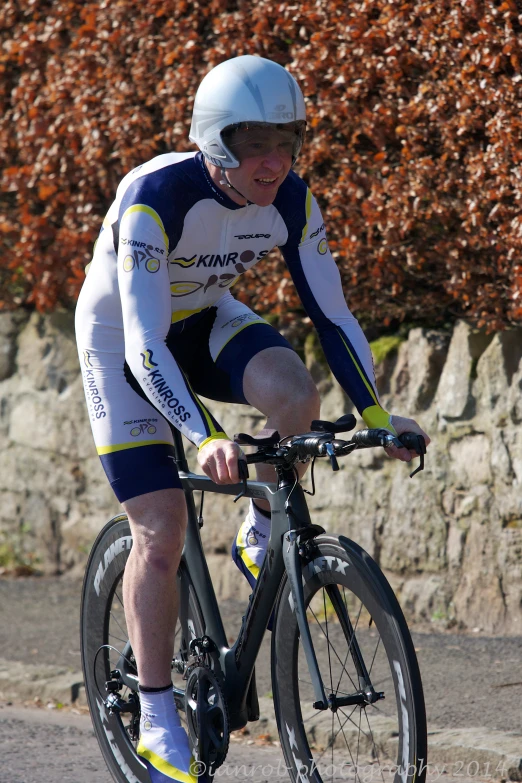 a man riding on the back of a bike down a road