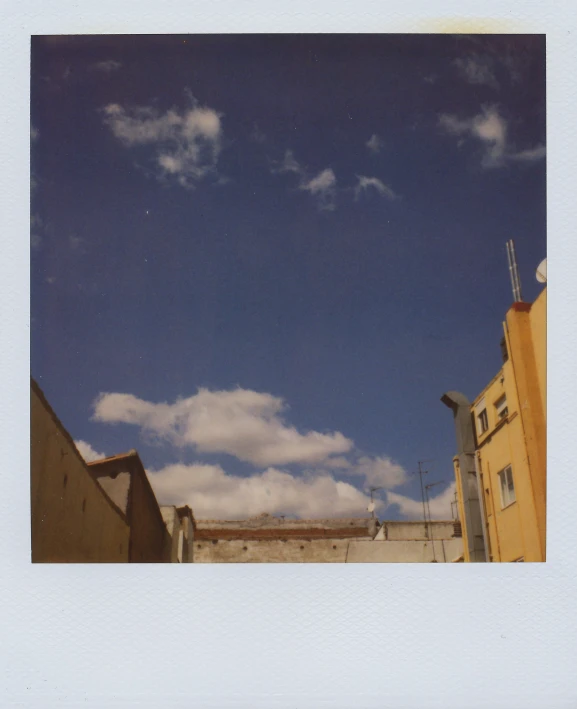 a white po with a few clouds over a yellow building