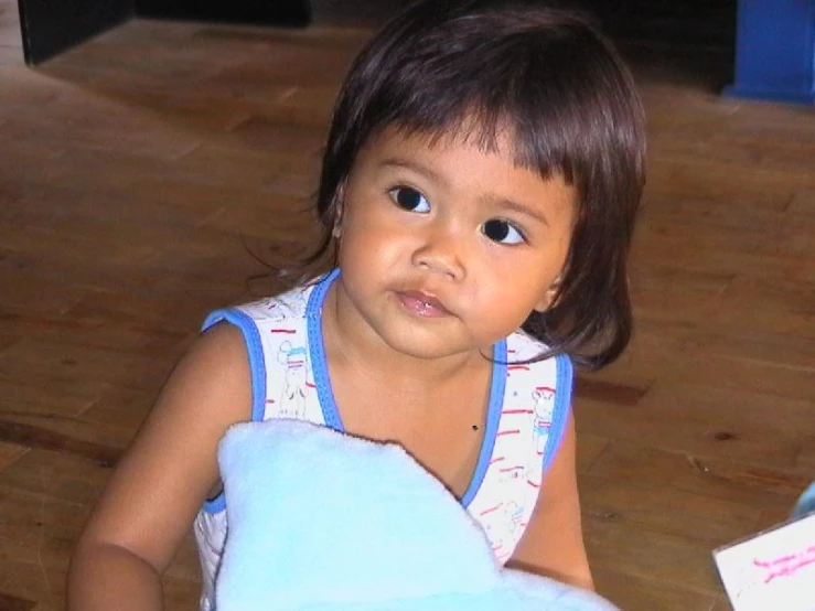 an adorable little girl holding a teddy bear