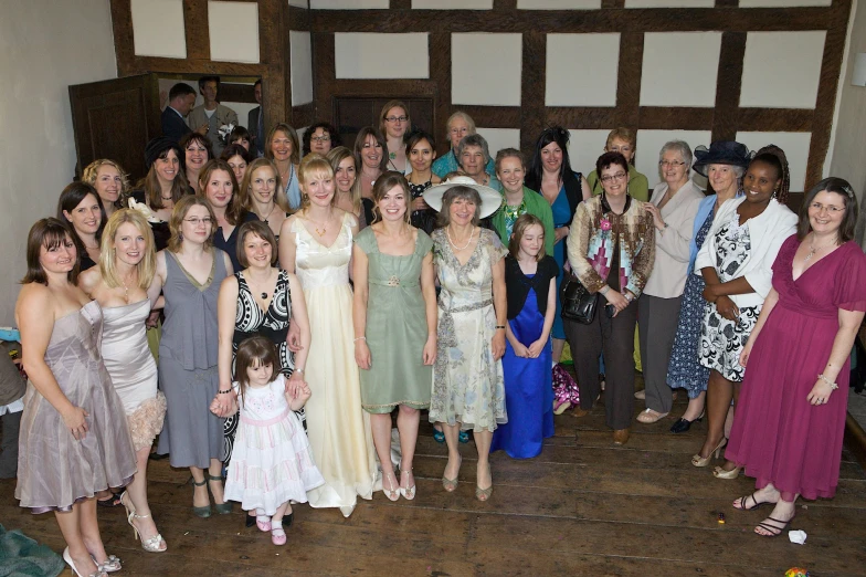 a group of people standing around each other in dresses