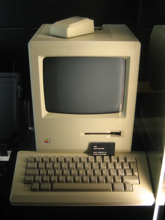 an old computer with keyboard and mouse sits on a table