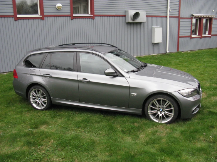 a grey car parked on top of green grass