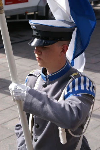 the soldier is wearing a hat and holding a flag