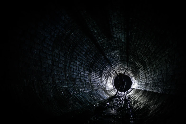 a lone figure in the dark with bright lights