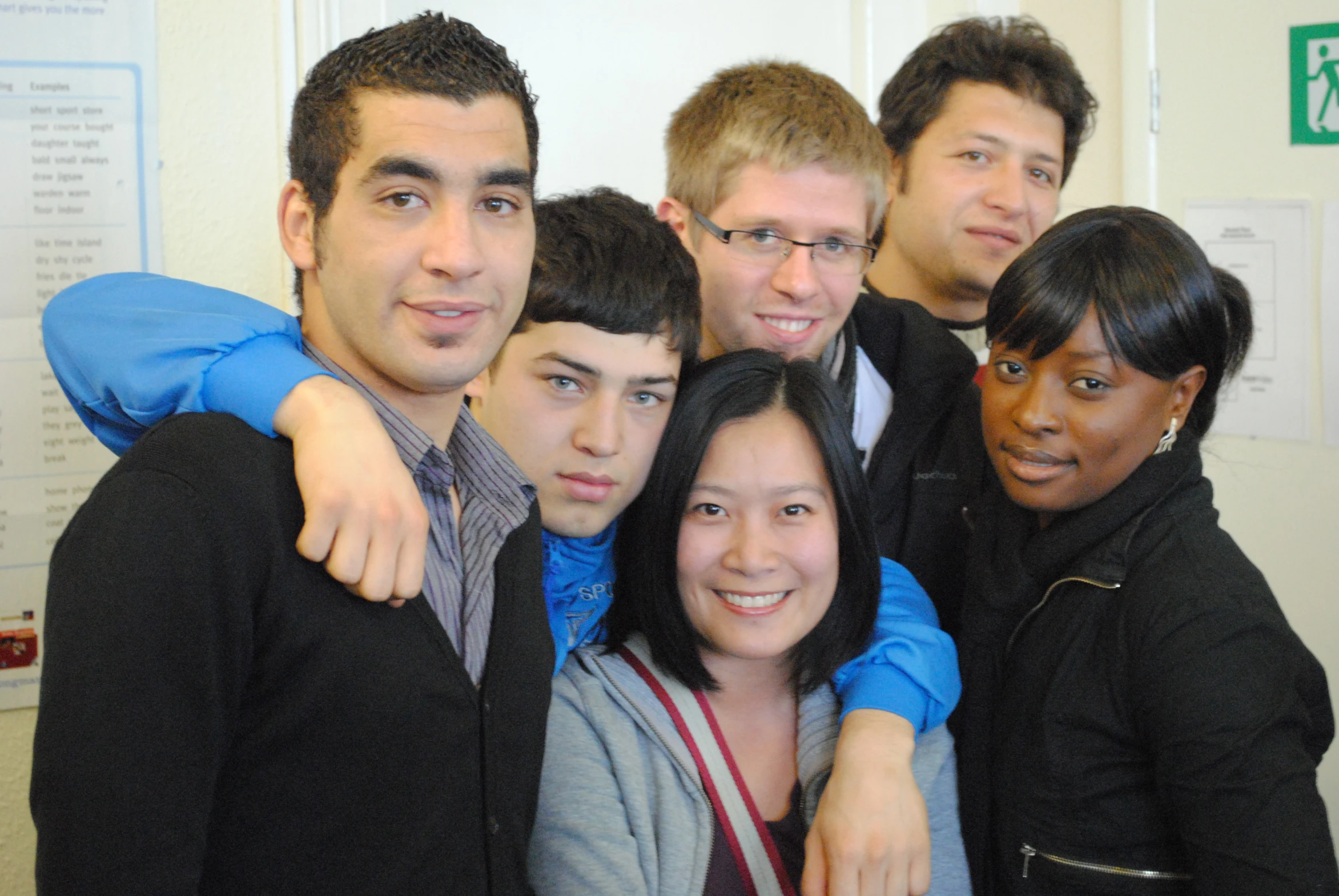 a group of people posing together in a building