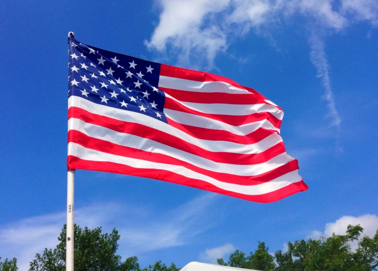 a large american flag flying in the sky