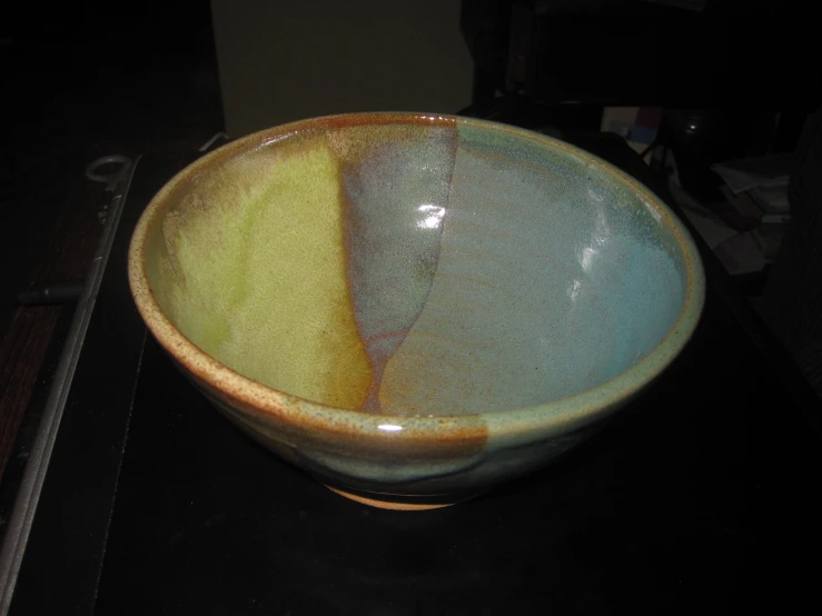 the bowl is green and yellow with some brown in it