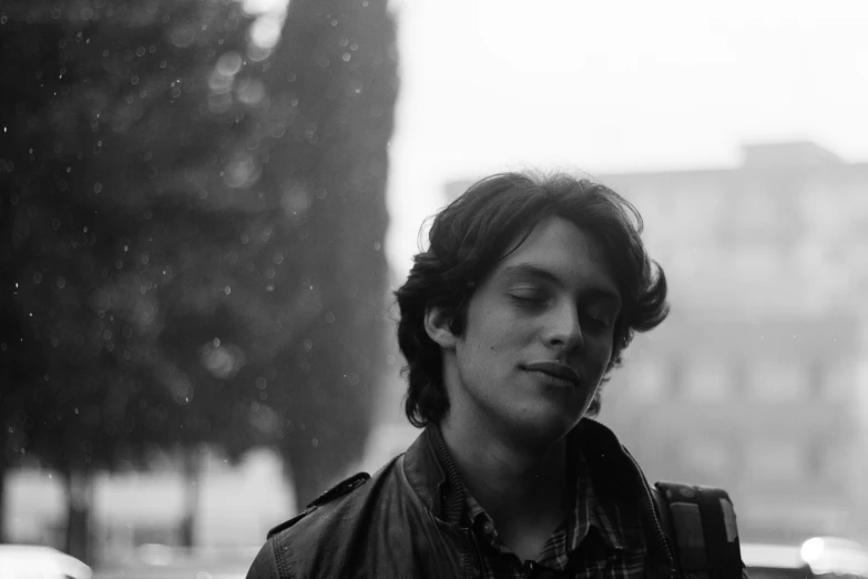 black and white pograph of person standing on sidewalk