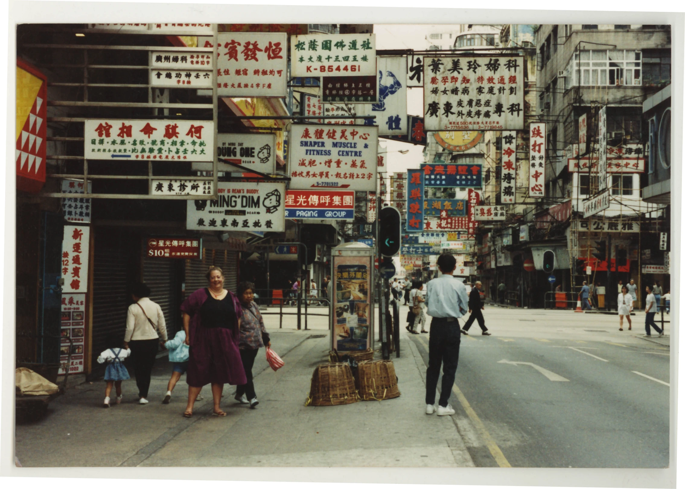 a group of people walking down a street near stores