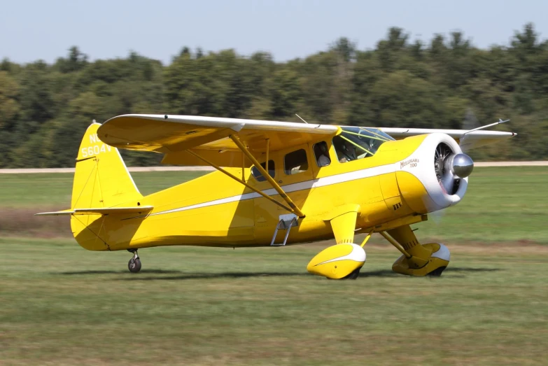 a yellow and white airplane is on the runway