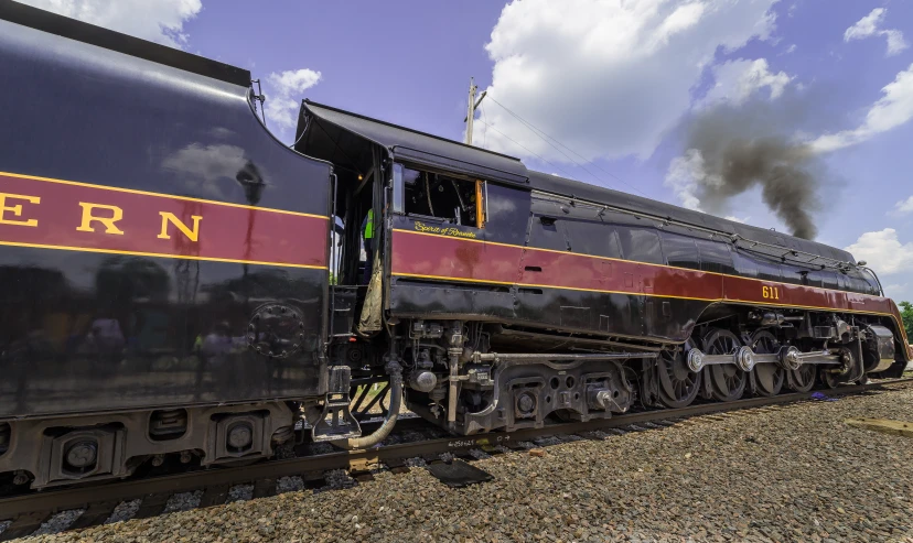 a locomotive on tracks pulling into the station