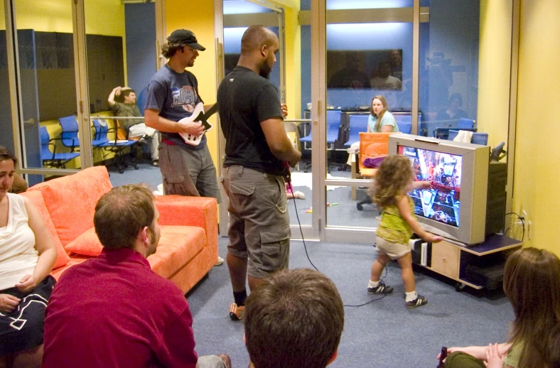 a group of people standing around playing video games