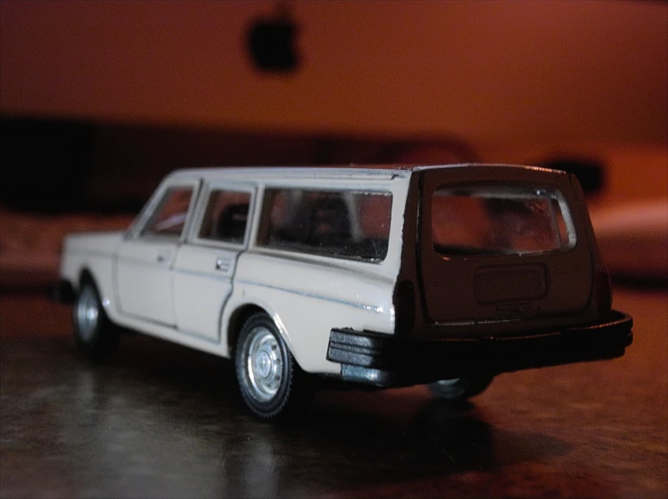 a small white car sitting on top of a table