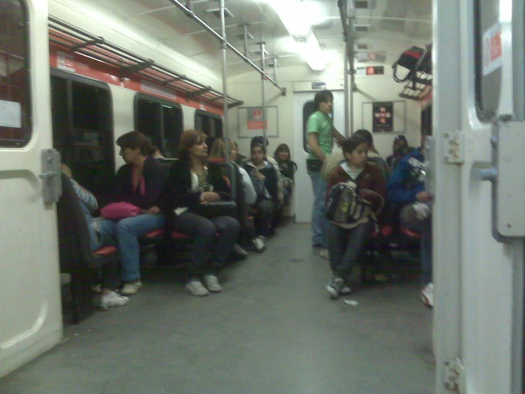 many people are sitting in the subway car