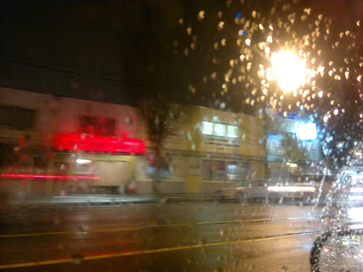 a po taken through a wet windshield with buildings in the background