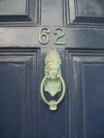 a large blue door with a large metal handle