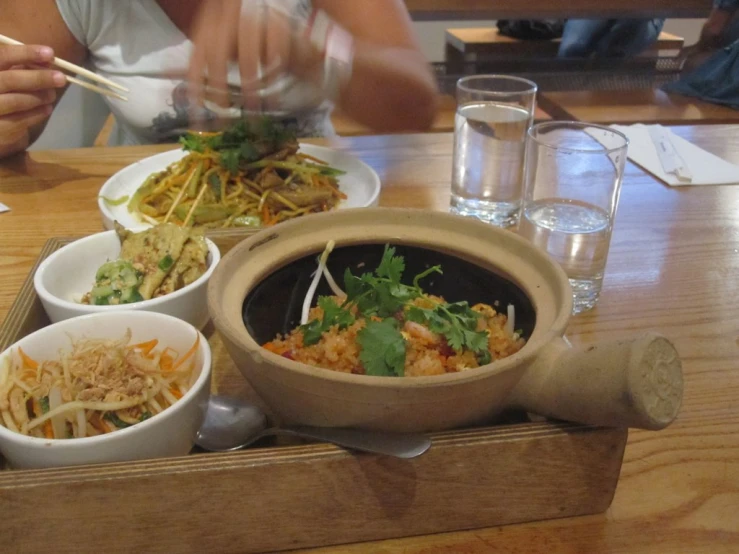 bowls are filled with various dishes on a tray
