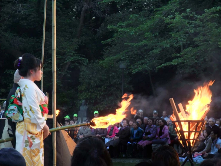 an asian fire dance show in front of a crowd