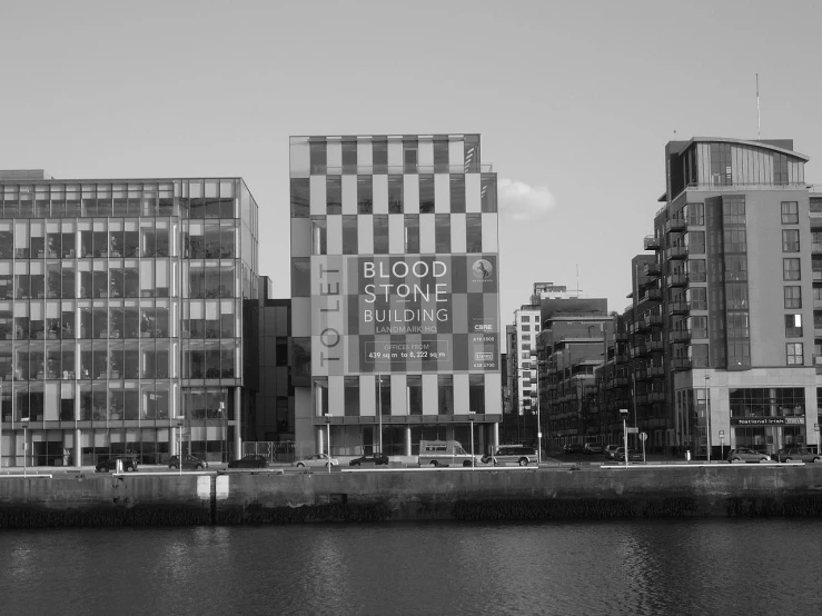 the buildings at an industrial area are reflected in the water