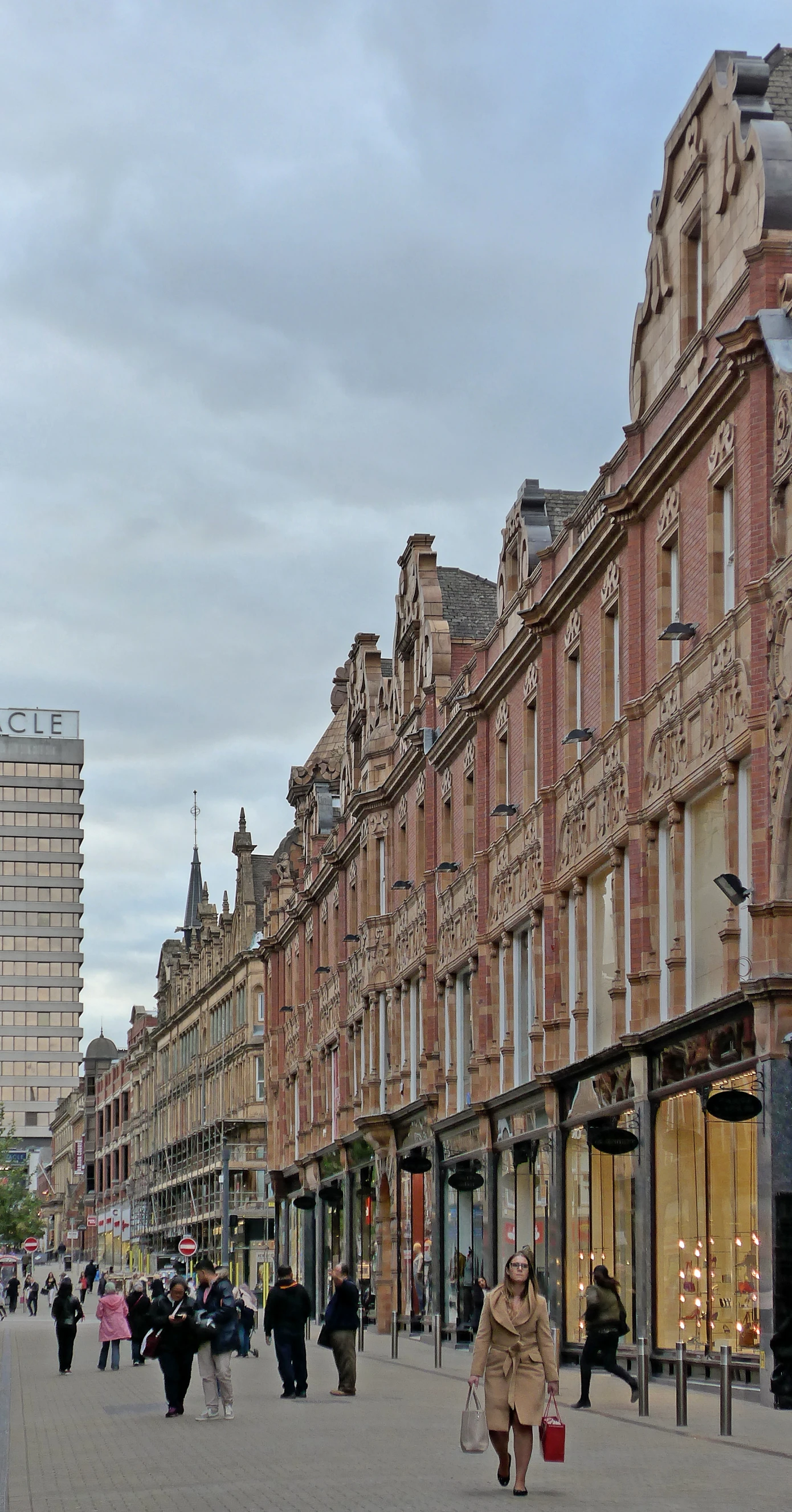 people are walking down an empty city street