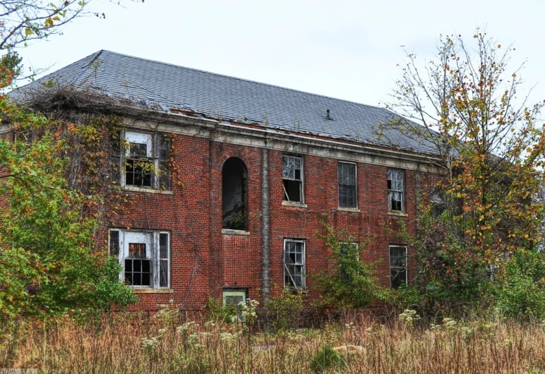 a very old building near some trees and bushes