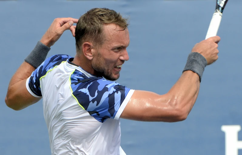 a man playing tennis, swinging the racket